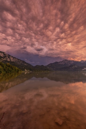 Stormy atmosphere, mountains reflected in lake, Lake Kochel, Alpine foothills, Bavaria, Germany, Europe