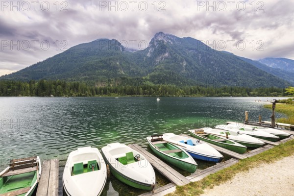 Jetty with boats at Hintersee, with green mountains in the background, peaceful and idyllic natural scenery, Ramsau, Berchtesgaden National Park, Berchtesgadener Land, Upper Bavaria, Bavaria, Germany, Europe