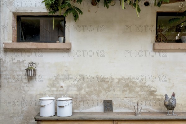 Two old enamel buckets and decorative objects on an old wooden bench, Alsace, France, Europe