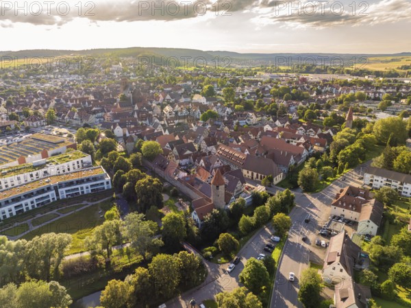 Aerial view of a busy city centre with red roofs and green trees in the early evening, Weil der Stadt, Germany, Europe
