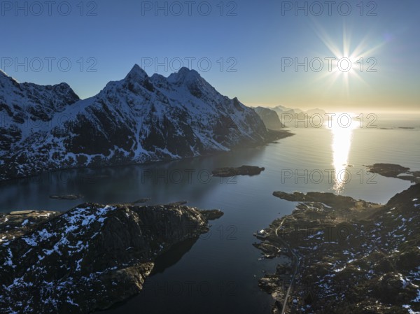 Aerial view of fjord and steep mountains, coast, winter, evening light, sun rays, Vestvagoya, Lofoten, Norway, Europe