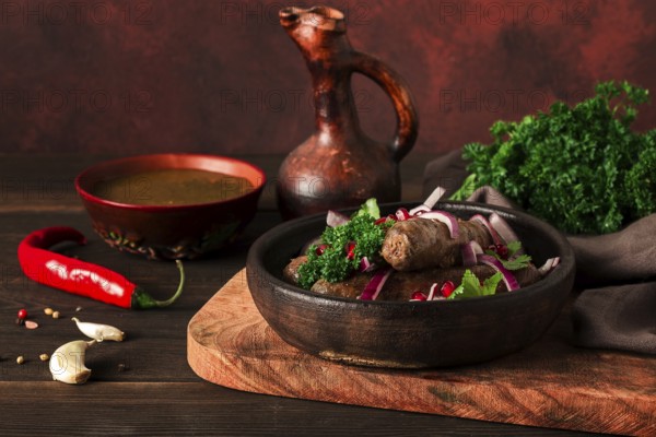Georgian dish, fried Kupaty sausages, Ketsi on a traditional clay pan, horizontal, no people, selective focus, toned