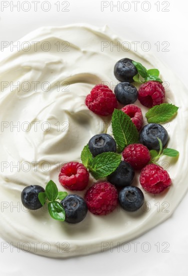 Breakfast, yogurt with fresh berries, raspberries and blueberries, on a white background, selective focus, no people, healthy food