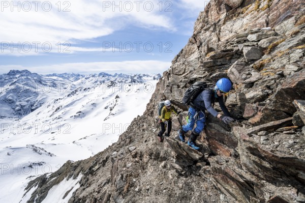 Two mountaineers climbing up a narrow mountain path, ascent to the summit of Piz Grialetsch in winter, Grisons Haute Route, Albula Alps, Rhaetian Alps, Grisons, Switzerland, Europe