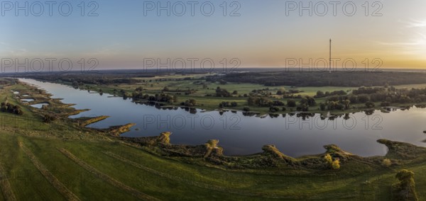 Panorama aerial view of river Elbe near Lenzen, view towards Höhbeck radio mast, calm summer evening, Germany, Europe