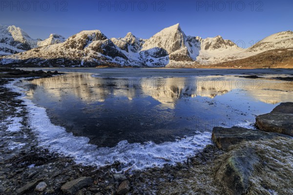 Sunrise, morning light, steep mountains and fjord, ice, winter, Flakstadoya, Lofoten, Norway, Europe