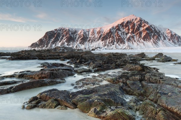 Winter evening mood at Skagsanden, rocks on the beach near Flakstad, Flakstadøy, Lofoten, Nordland, Norway, Europe