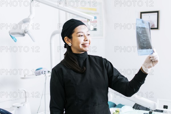 A dentist checking an x-ray, A dentist checking an x-ray, A dentist checking a radiological analysis