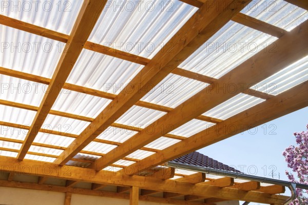 New patio roofing with wood and corrugated acrylic glass panels