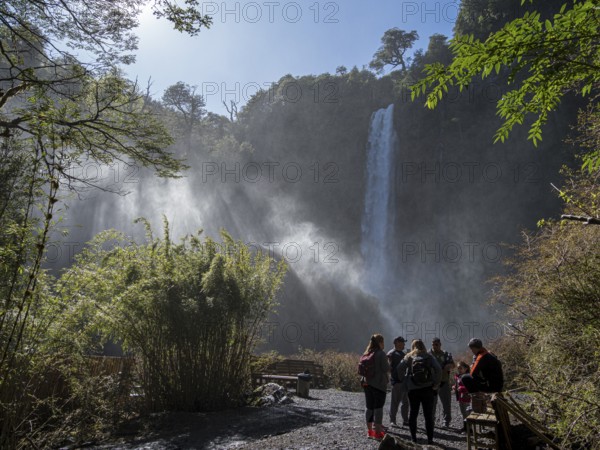 Tourists in front of waterfall Salto El Leon, valley of waterfalls east of Pucon, La Auracania, Chile, South America