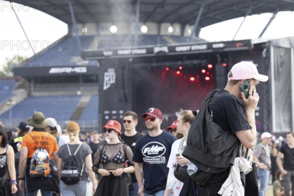 Adenau, Germany, 8 June 2024: Fans enjoy Rock am Ring Festival. The festival takes place at the Nürburgring race track near the town of Adenau from 7 to 9 June 2024, Europe