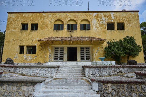 An old yellow dilapidated building with a damaged façade and a staircase in the entrance, Italian Governor's Palace, Ruins, Italian colonial settlement, Eleousa, Rhodes, Dodecanese, Greek Islands, Greece, Europe