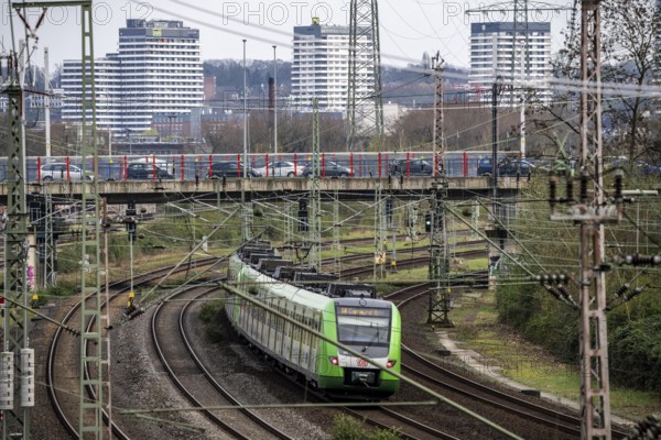 S-Bahn train on the railway line between Mülheim an der Ruhr, in the background and Duisburg, busy railway line, for local and long-distance traffic, freight traffic, North Rhine-Westphalia, Germany, Europe