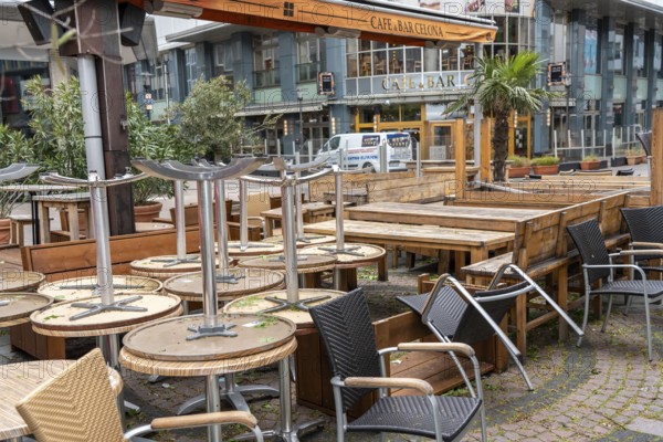 Stacked chairs and tables from various catering establishments, on Kennedyplatz, closed cafes, pubs, restaurants, effects of the lockdown in the corona crisis in Essen, North Rhine-Westphalia, Germany, Europe