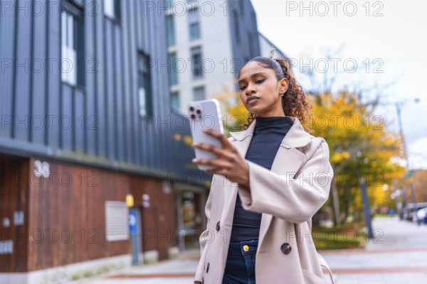 Beauty african woman using smartphone to find a direction in the city