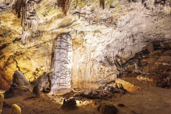 Stalagmites and stalactites creating a brilliant column inside postojna cave, a famous tourist attraction in slovenia