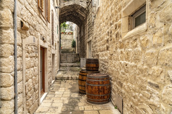 Barrels in a narrow alley in the old town of Korcula, Croatia, Europe