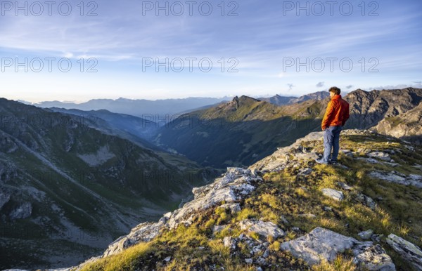 Mountaineer at the summit of Mont de la Blana, mountain landscape at sunset, view over the valley of la Dixence, Hérémence, Valais, Western Alps, Switzerland, Europe