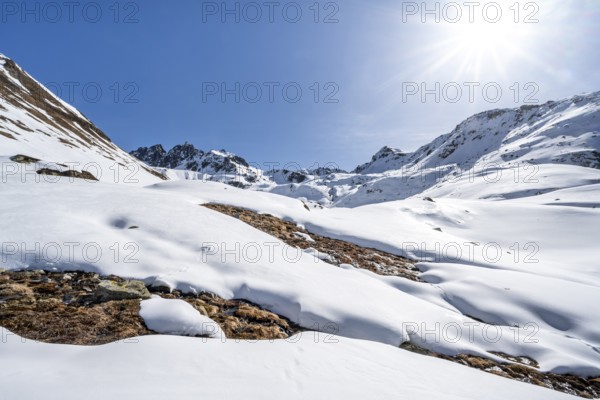 Mountain landscape with snow and sun star, ascent to Grialetsch Scharte, Bündner Haute Route, Albula Alps, Rhaetian Alps, Grisons, Switzerland, Europe