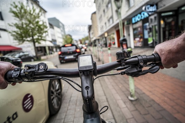 Cycling in the city, inner-city street, cycle lane, bicycles have priority, two-lane traffic with parked cars on both sides, cyclists' perspective, Essen, North Rhine-Westphalia, Germany, Europe
