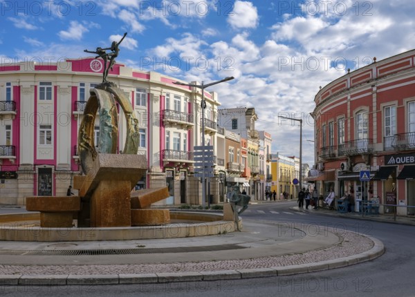 Loule, Algarve, Portugal - Houses with colourful facades in the old town of Loulé, roundabout with fountain in the town centre