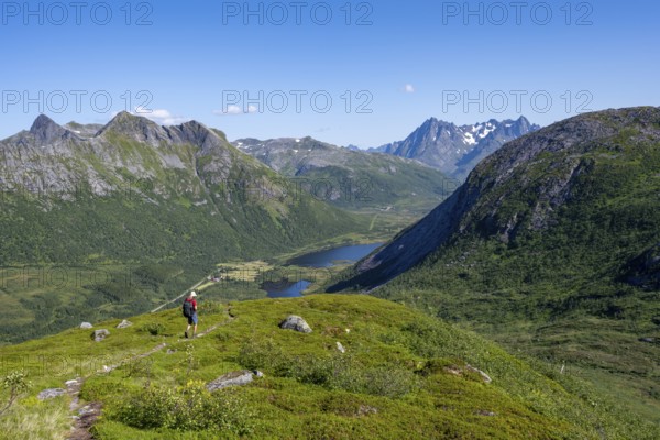 View of mountain landscape, mountaineer on hiking trail to the summit of Rundfjellet, Svolvaer, Nordland, NorwayView of mountain landscape, mountaineer on hiking trail to the summit of Rundfjellet, Svolvaer, Nordland, Norway, Europe