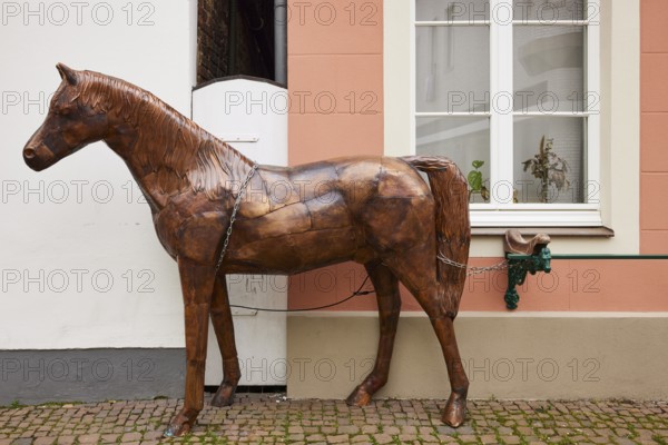 Brass horse sculpture with iron chain in the town of Warendorf, Warendorf district, North Rhine-Westphalia, Germany, Europe