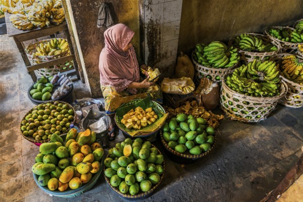 Traditional authentic food market, vendor, woman, fruit, vegetable, fresh, food, nutrition, sale, trade, bazaar, authentic, disease vector, food law, food control, stall, Asian, vegetable market, local, hygiene, virus, tradition, traditional, health, marketplace, market hall, tropical, travel, tourism, culture, poverty, presentation, cleanliness, person, Muslim, Islam, Lombok, Indonesia, Asia