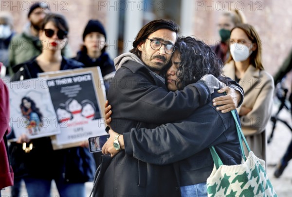 An Iranian couple embrace during a demonstration by Iranians in solidarity with the people of Iran