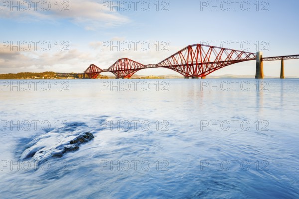 View of the red railway bridge Forth Bridge at the Fírth of Forth estuary near South Queensferry, Scotland, Great Britain