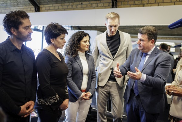 (L-R) Hubertus Heil (SPD), Federal Minister of Labour and Social Affairs, Daniel Terzenbach, Director of Regions at the Federal Employment Agency and Special Representative of the Federal Government, and Cansel Kiziltepe, Senator for Labour, Social Affairs, Equality, Integration, Diversity and Anti-Discrimination in Berlin, in conversation with Valentyna Vysotska, hairdresser from Ukraine, at the Coiffeur Civan hairdressing salon in Berlin, 22.04.2024