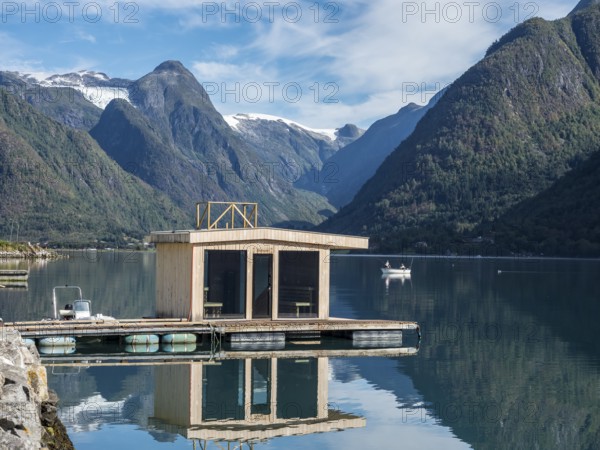 Floating sauna, village Fjaerland at the Sognefjord, glacier Jostedalsbre in the back, Norway, Europe