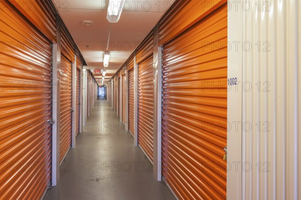 Orange interior of self storage rental units at an enclosed mini warehouse facility in Gulfport, Mississippi, USA, North America