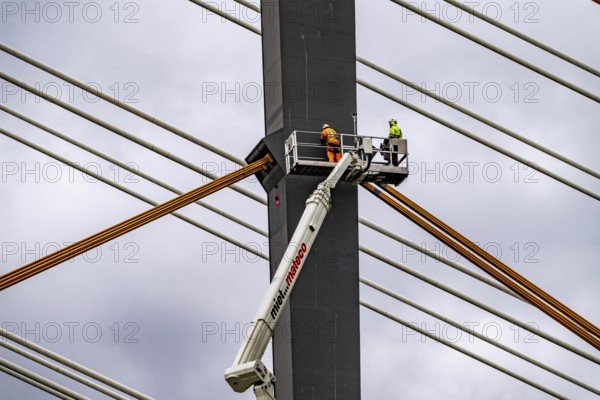 The new Rhine bridge Neuenkamp, the A40, white pillar ropes, and the old motorway bridge, which is being dismantled, preparation for demolition, workers on cherry pickers measure, mark the old bridge pillar, Duisburg, North Rhine-Westphalia, Germany, Europe