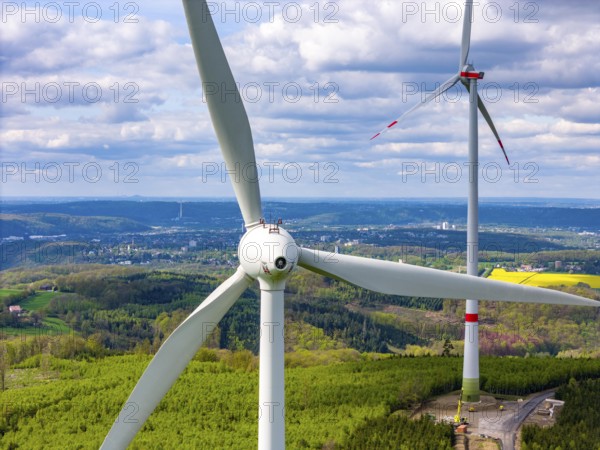 Erection of a wind turbine, wind energy plant, assembly of the ring generator, with a crawler lattice crane, wind farm near Hagen, North Rhine-Westphalia, Germany, Europe