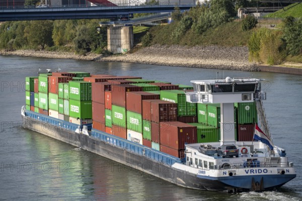 The Dutch cargo ship Vrido, loaded with containers, on the Rhine near Duisburg, downstream, North Rhine-Westphalia, Germany, Europe