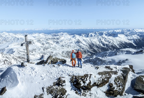 Two ski tourers on the summit of Cevedale, Alpine panorama, Aerial view, Snow-covered mountain landscape, Ortler group, Trento, Italy, Europe