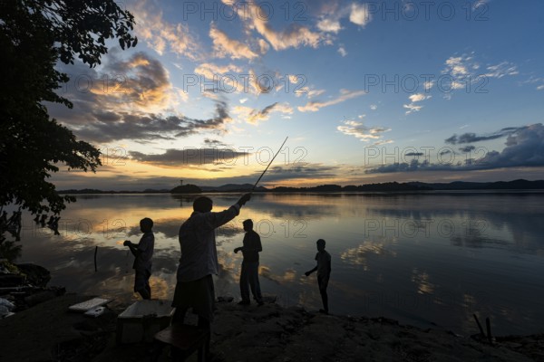 People fishing in the Brahmaputra river at the background during the sunset, in Guwahati, Assam, India on Tuesday, 18 August 2020