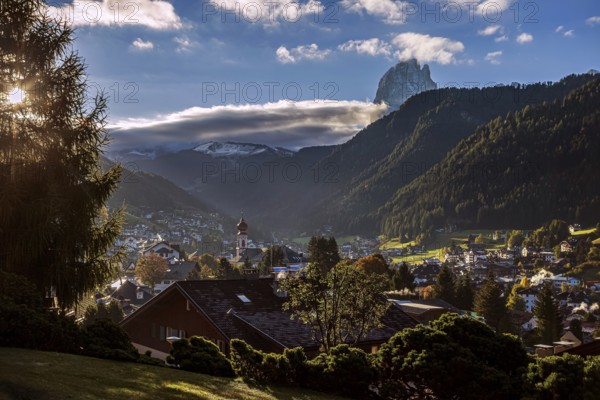 The mountain village of Ortisei in Val Gardena at sunrise, surrounded by wooded mountains and snow-capped peaks, picturesque atmosphere, Val Gardena, South Tyrol, Italy, Europe