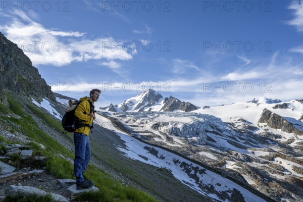 Mountaineer in front of high alpine mountain landscape, summit of the Aiguille de Chardonnet and Glacier du Tour, glacier and mountain peak, Chamonix, Haute-Savoie, France, Europe