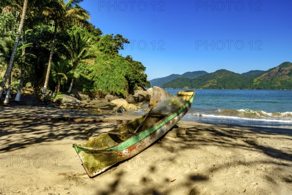 Fishing canoe over beach sandof Castelhanos beach in Ilhabela, Castelhanos beach, Ilhabela, Sao Paulo, Brazil, South America