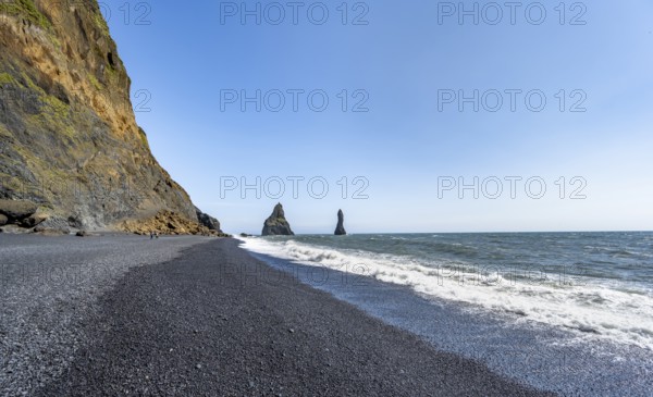 Black beach with cliffs, rock Reynisdrangar in the water, at Reynisfjara beach, Vik, South Iceland, Iceland, Europe