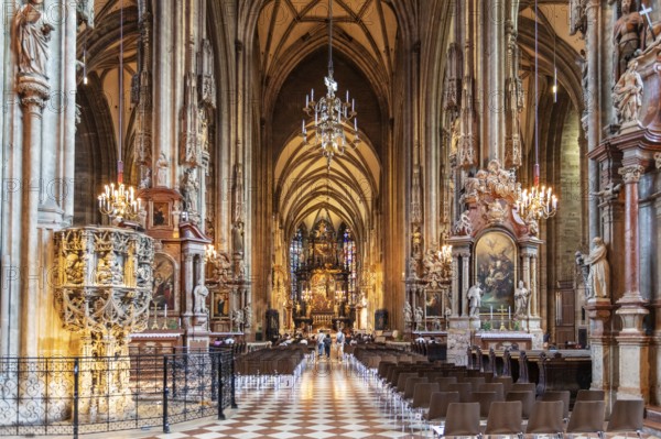 Magnificently decorated church interior with ornate vaults and rich lighting, Vienna