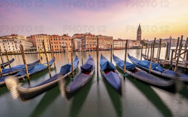 Venetian gondolas, boat dock at the customs office on the Grand Canal, Gondola Traghetto Dogana, Campanile behind, long exposure at sunrise, Venice, Veneto, Italy, Europe
