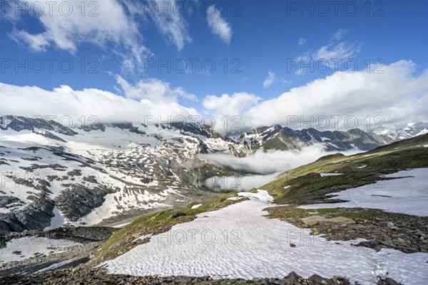Mountain landscape with snow fields and high fog in the valley, summit Hoher Weißzint and Hochsteller with glacier Schlegeiskees, Berliner Höhenweg, Zillertal Alps, Tyrol, Austria, Europe