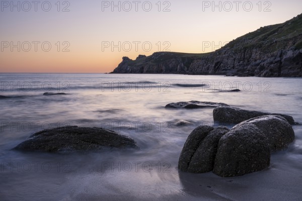 Coastal landscape. Rocks in the sea. In the evening after sunset. Long exposure. Nanjizal Bay, St Just, Penzance, Cornwall, England, Great Britain