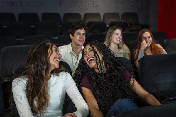 Friends enjoying laughter together while watching a comedy film at the cinema, sharing moments of joy and fun in a vibrant atmosphere