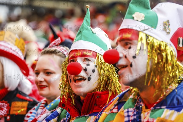 Colourfully costumed carnivalists celebrate carnival in Cologne, on Weiberfastnacht the street carnival is traditionally opened on the Alter Markt, which then reaches its climax on Rosenmontag, Cologne, Rhineland, North Rhine-Westphalia, Germany, Europe