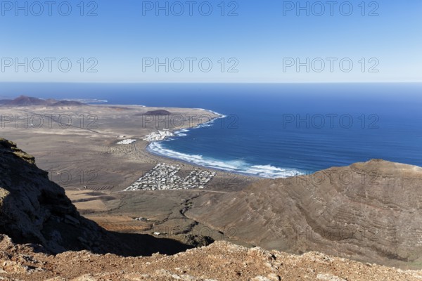 View of the coastline and the holiday homes, Mirador Ermita de las Nieves, Caleta de Famara, Lanzarote, Canary Islands, Spain, Europe