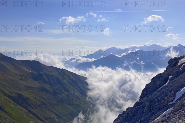 Clouds hanging low in drifting through alpine valleys alpine valleys mountain valleys below mountain peaks mountain peaks, Stelvio Pass, Stelvio, Autonomous Province of Bolzano, Italy, Europe
